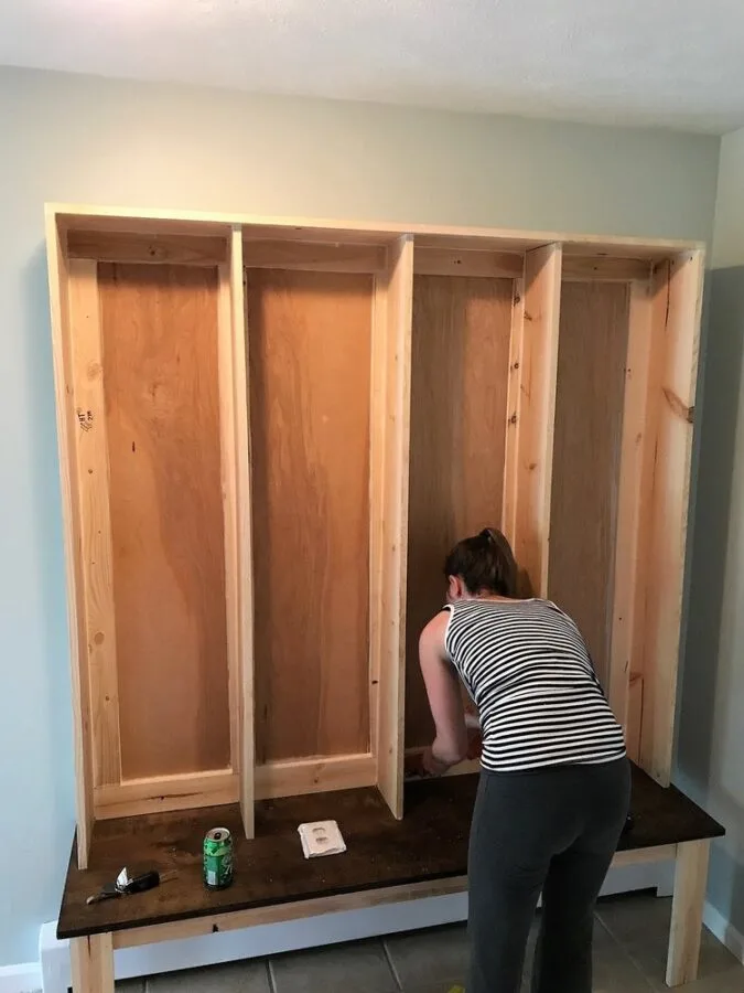 Calking the new DIY bench & locker system in the mudroom.