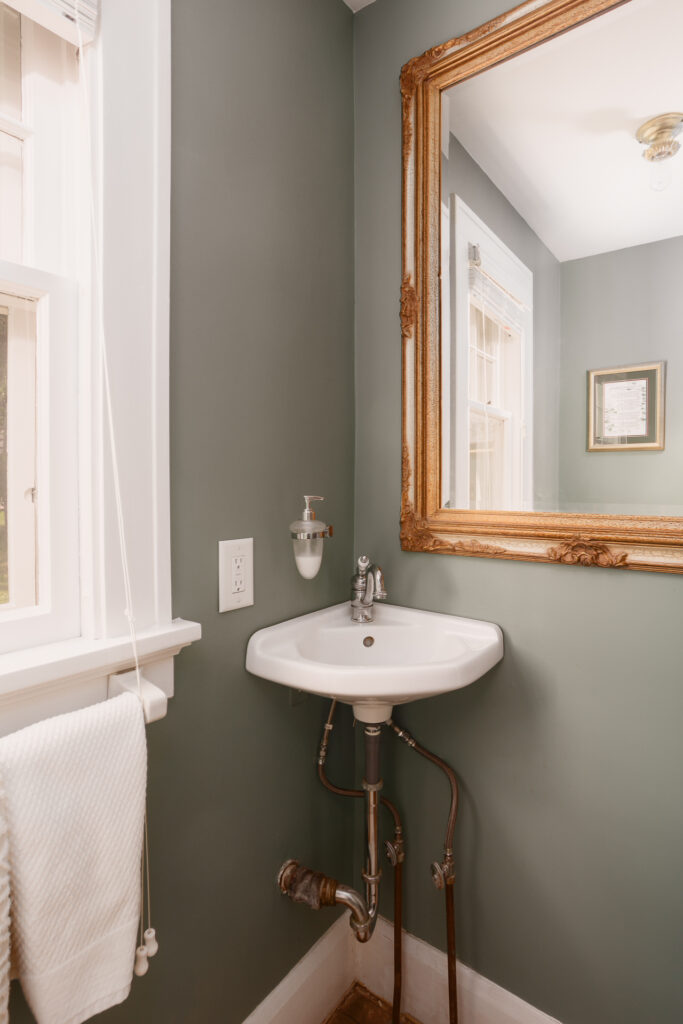 Half bathroom with vintage charm in the historic Colonial home | Building Bluebird