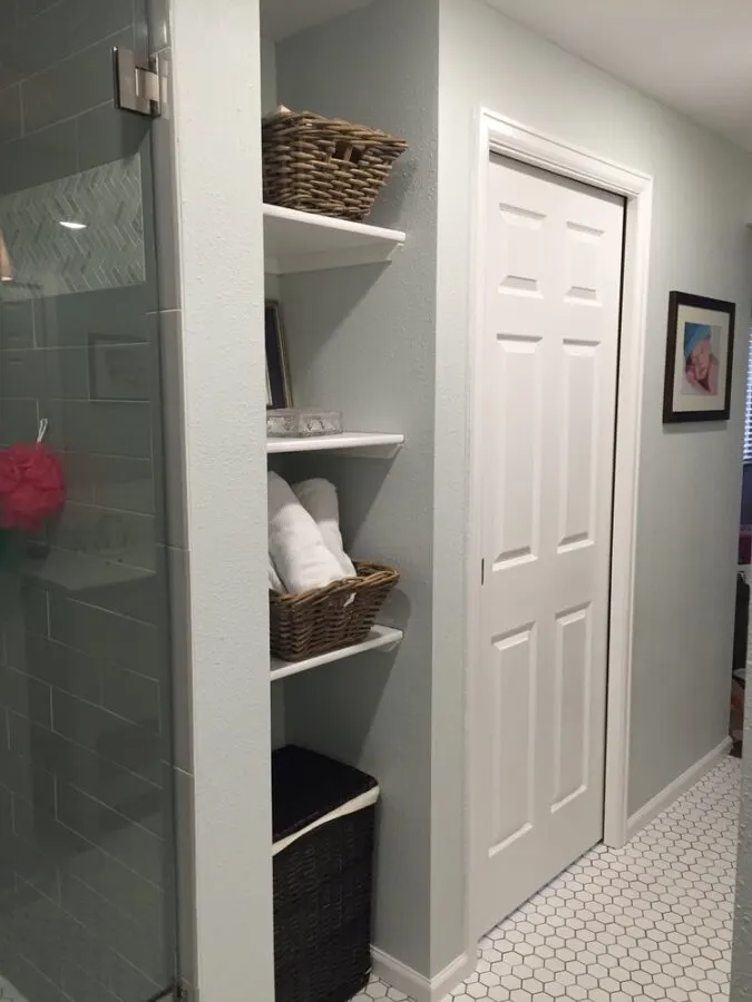 The shelving nook in our master bathroom that offered ample storage and the perfect spot for the clothes hamper.