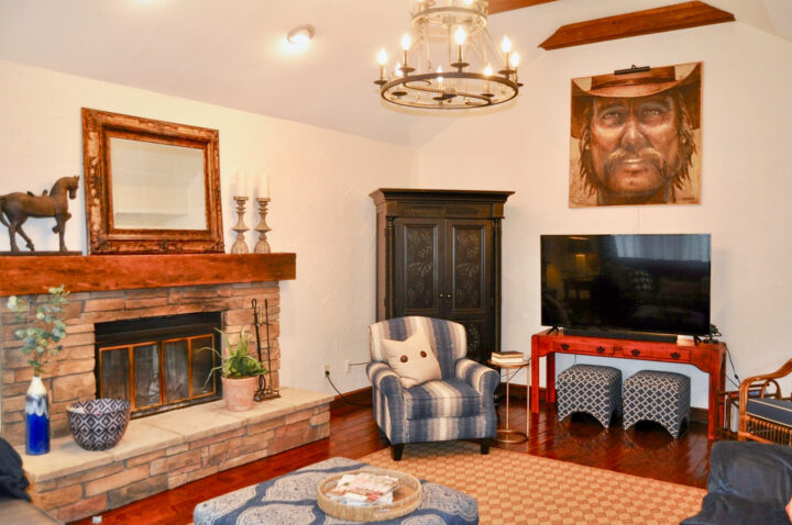 Vaulted ceiling family room staged with neutral decor and pops of blue
