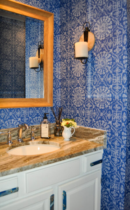 Bold blue wallpaper in small powder room for a punch of personality