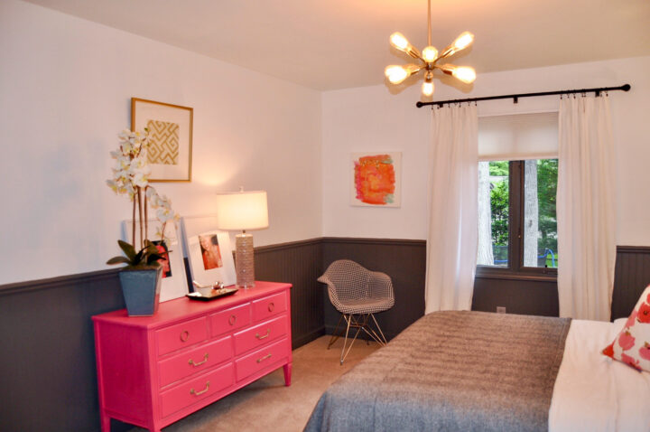 Bedroom styled with a neutral design and a pop of pink