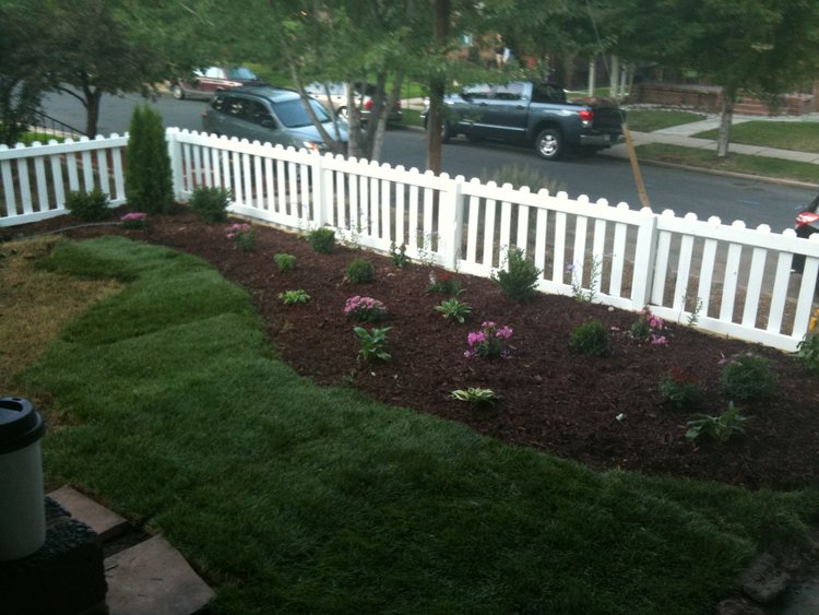 New flower beds and white picket fence to increase curb appeal