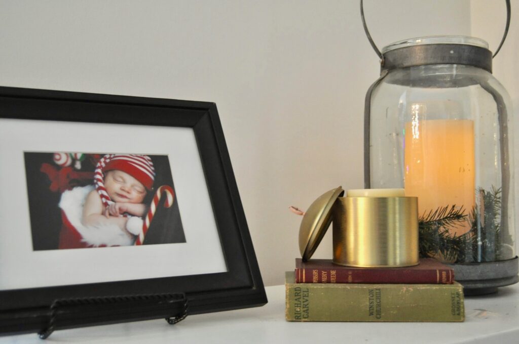 Use Christmas tree trimmings to surround a candle in a lantern to decorate for the holidays