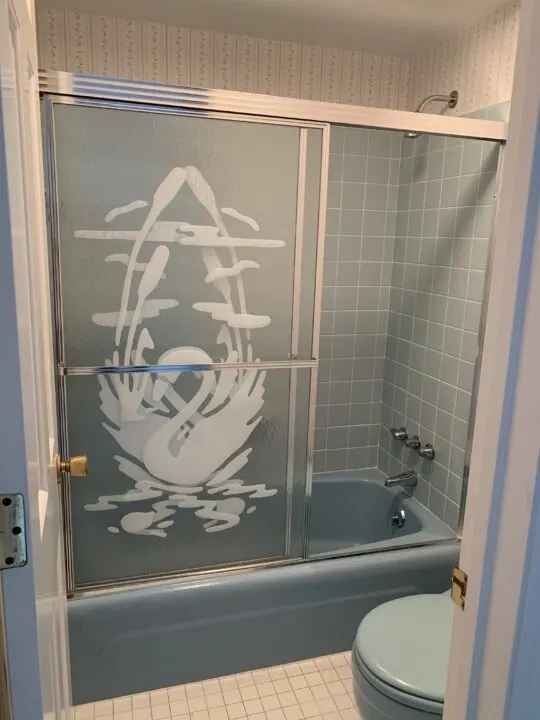 Retro bathroom with blue tiles & swan doors
