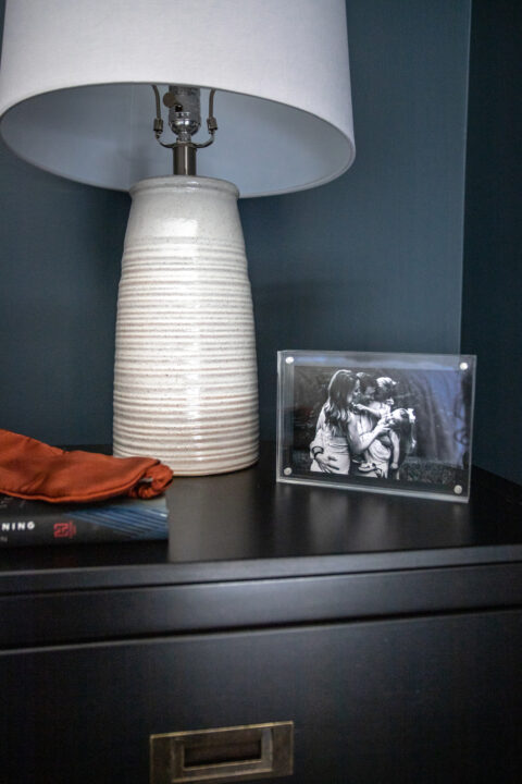Simple nightstand decor with family photos for a personal touch | Building Bluebird #moodybedroom #moodypaint #bhgorc
