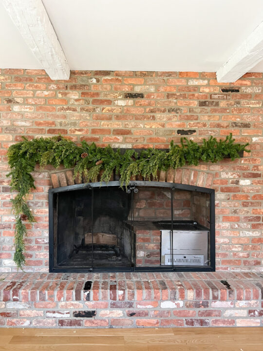 How to hang Christmas garland on your fireplace mantel with an asymmetrical design | Traditional Christmas