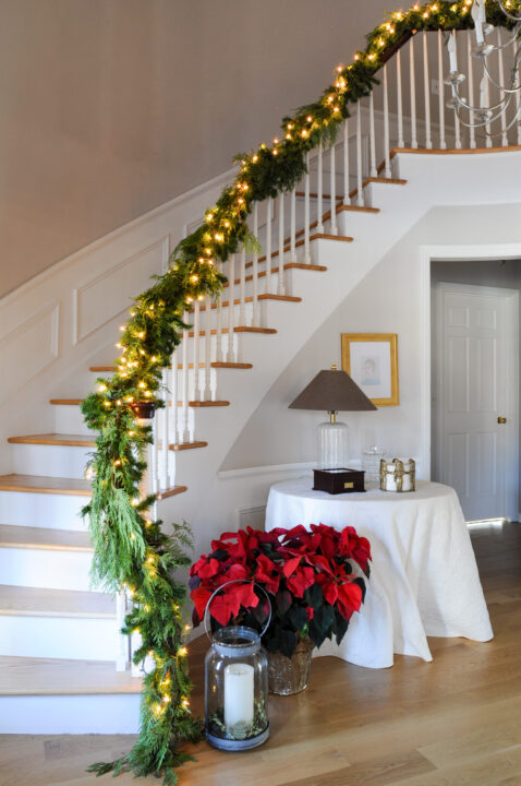 How to DIY and hang a Christmas garland on your staircase | Budget-friendly